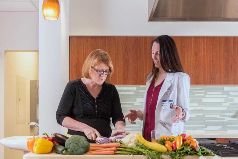 NM employee with a patient in the Delnor Metabolic Health and Surgical Weight Loss Center kitchen.