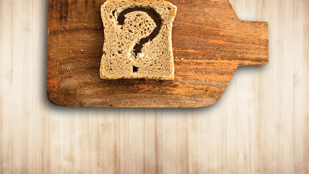 A slice of wheat toast with a question mark cutout.