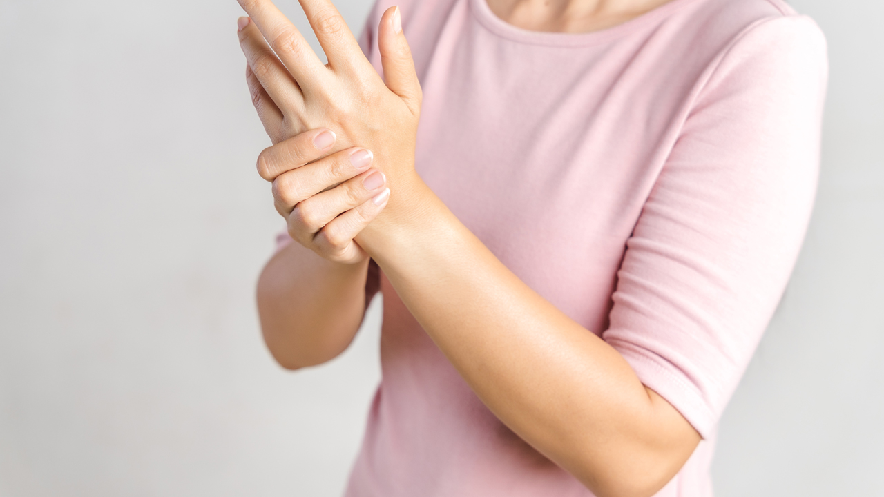 A person holding their wrist. 