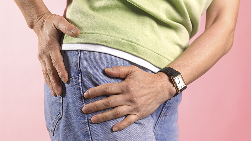Person holding their hip.