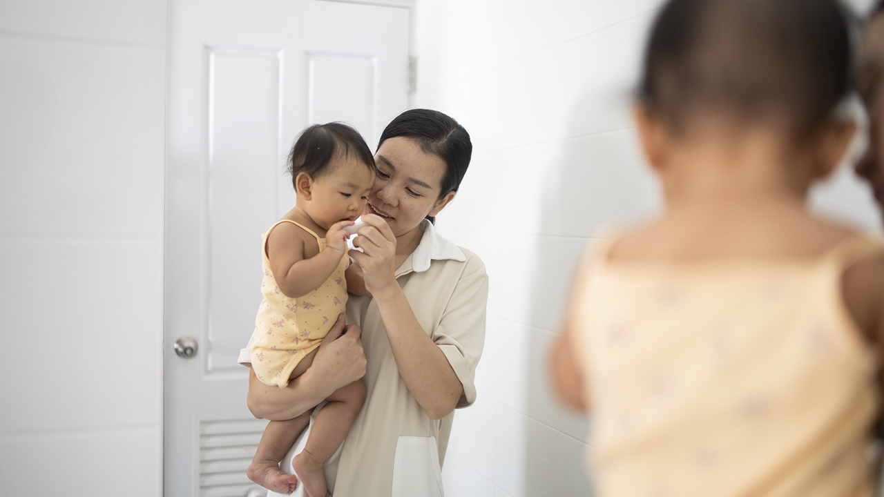 mom holding toddler in her arms