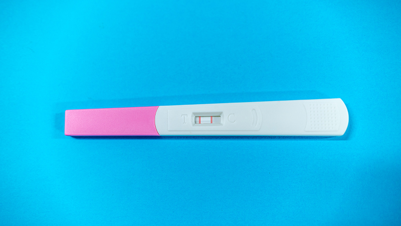Pregnancy test on a blue blackground.