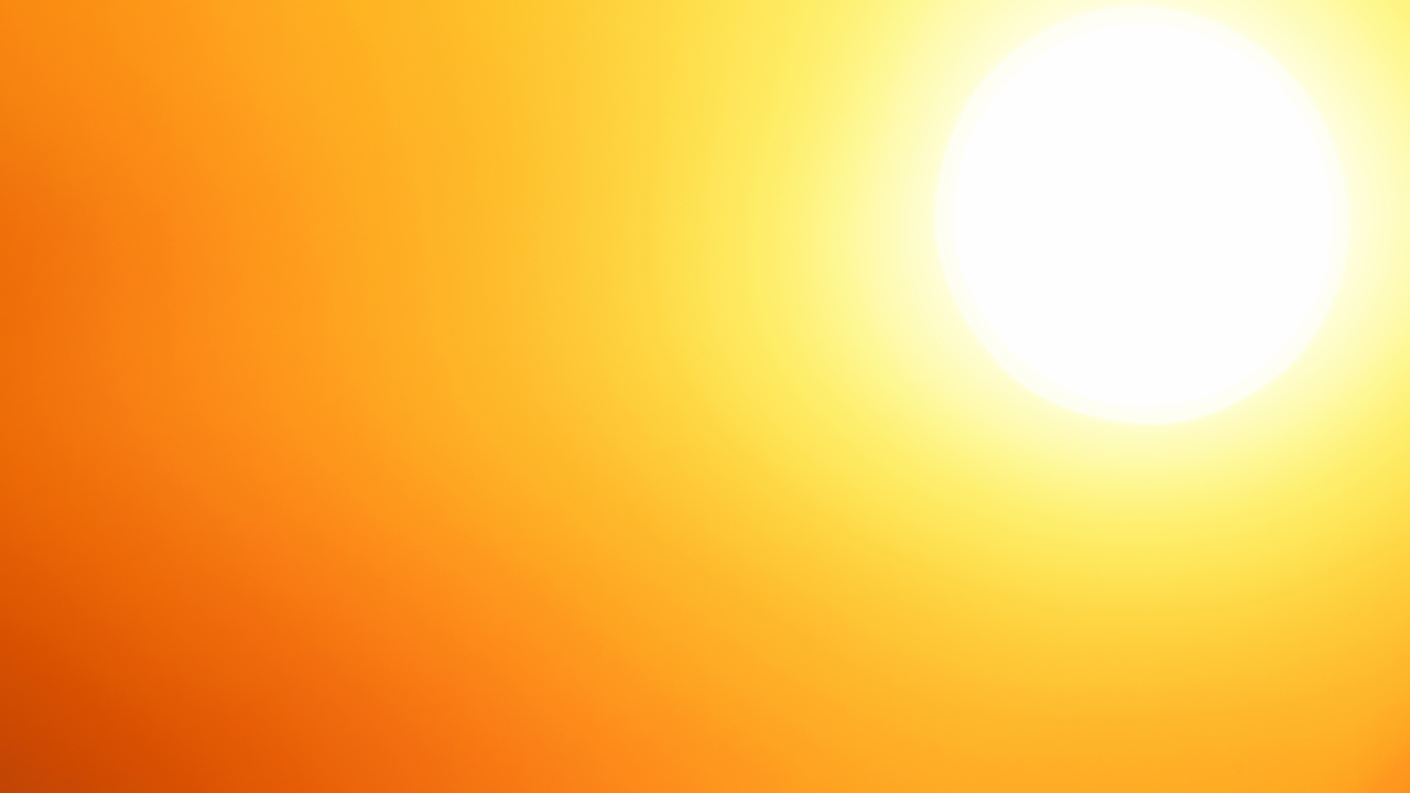 White hot sun on an orange and yellow background. 
