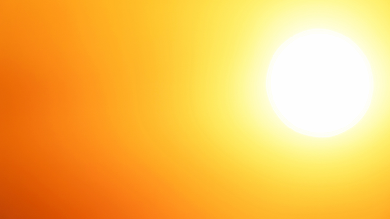 White hot sun on an orange and yellow background. 