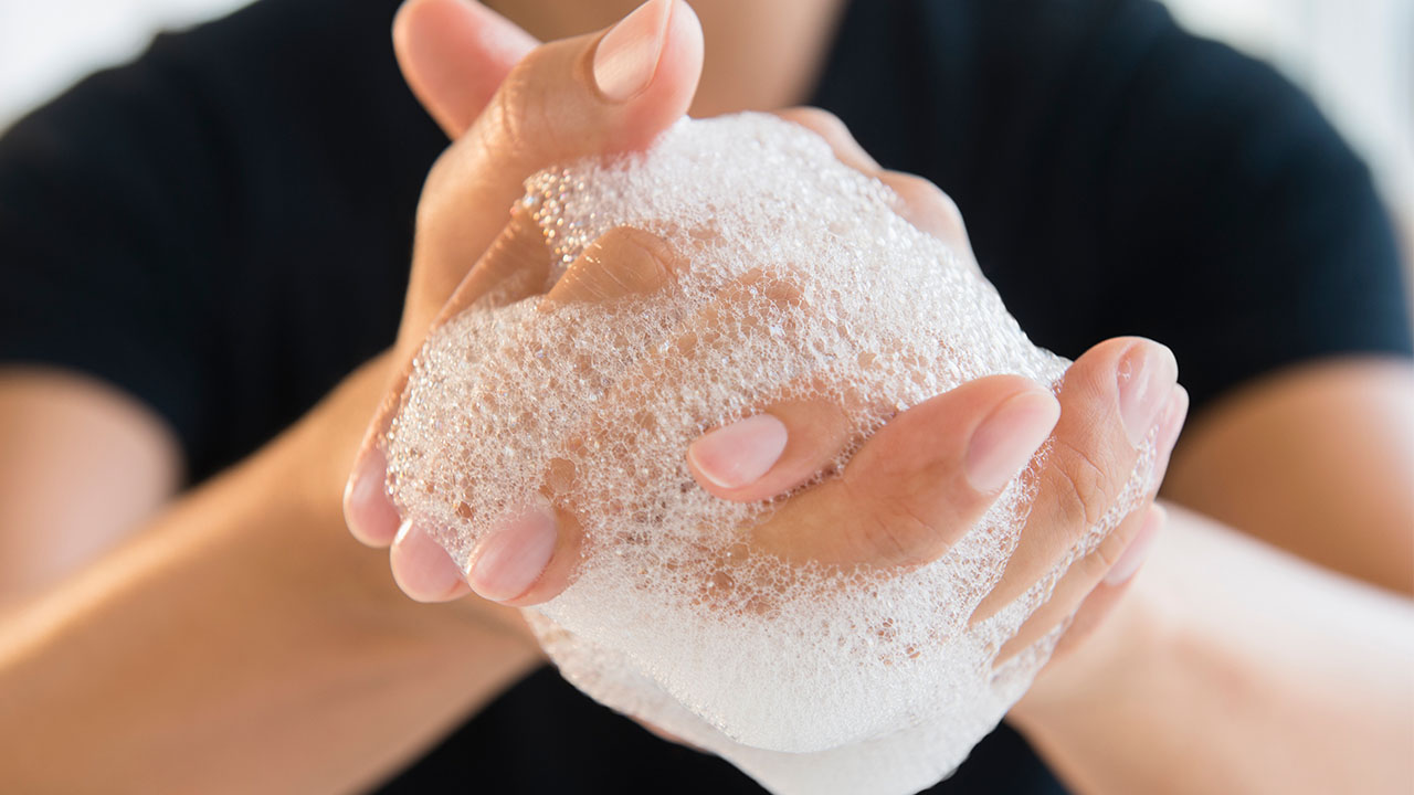 close up of man's soapy hands