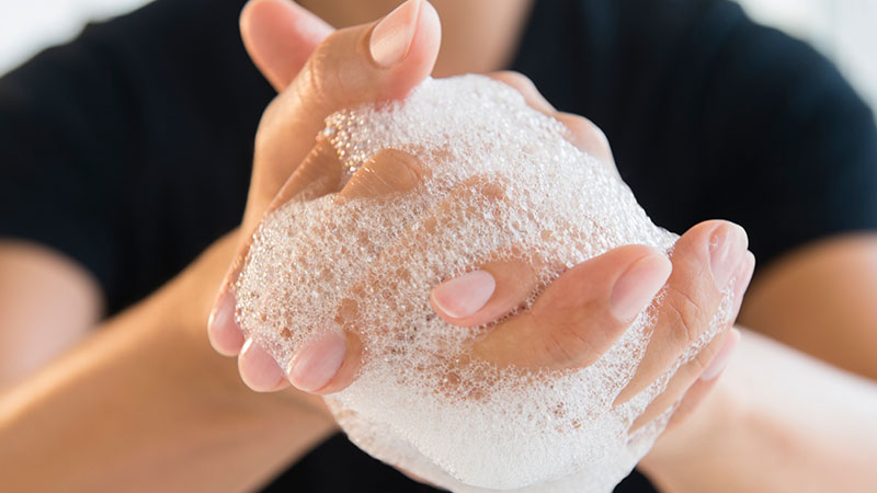 close up of man's soapy hands