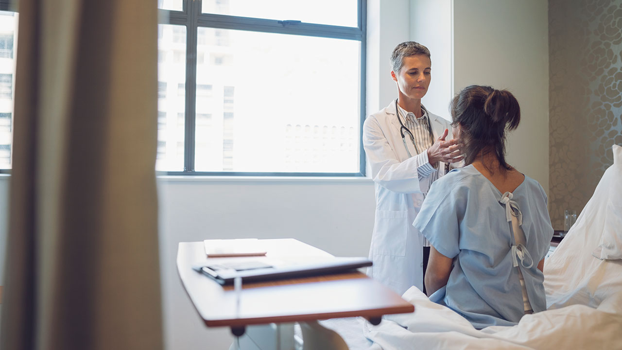 doctor examines patient's neck
