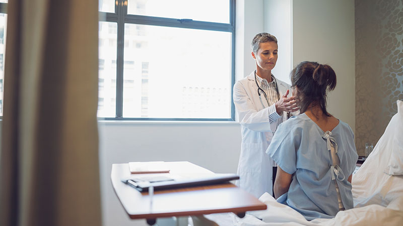 physician examines patient's neck