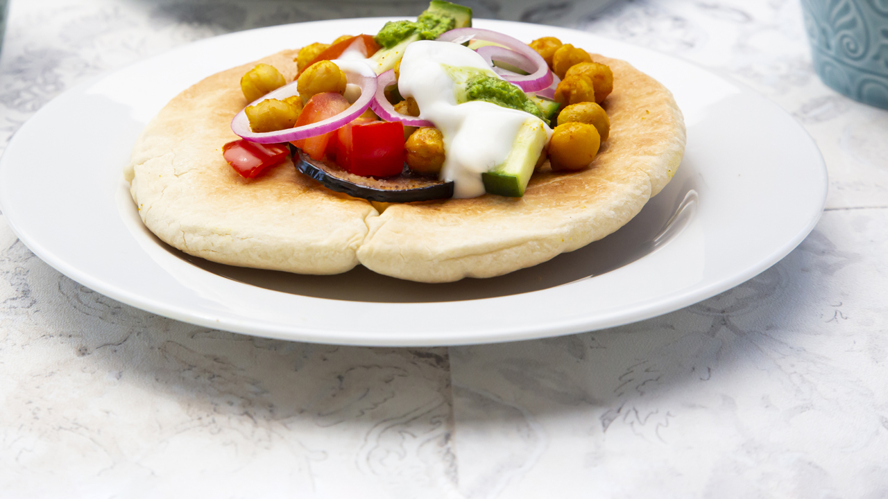 Chickpea gyros with vegetables and tzatziki sauce.
