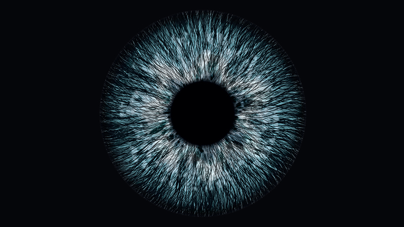 Light blue iris and black pupil on a black background, suggestive of an eye exam.