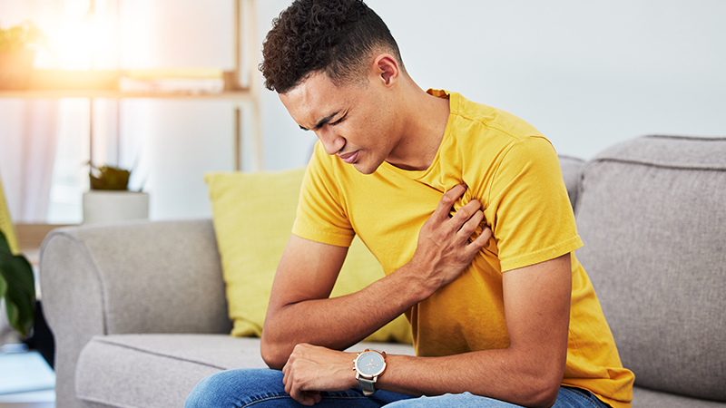 Young person clutching their chest.