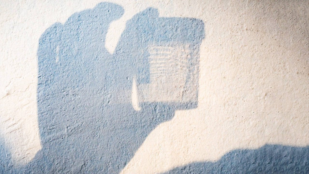 Shadow of someone holding a urine sample.  