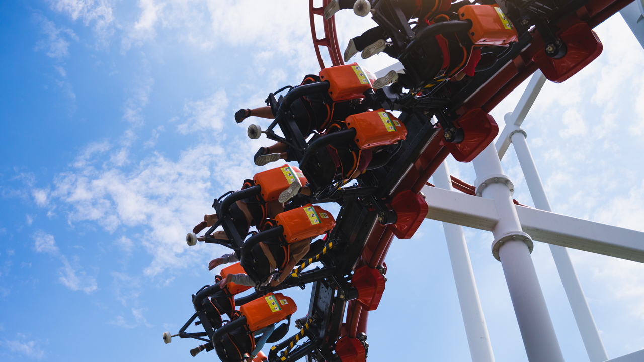 A close-up of a scared person peeking through their hands.