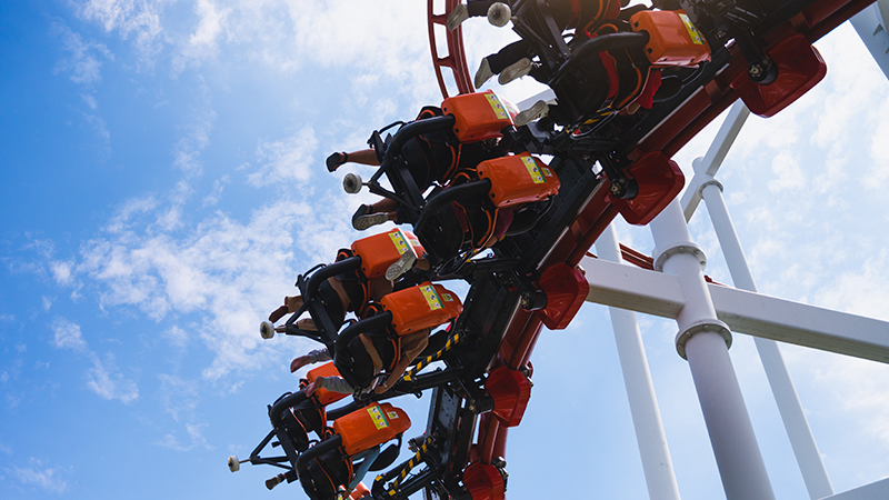 A close-up of a scared person peeking through their hands.
