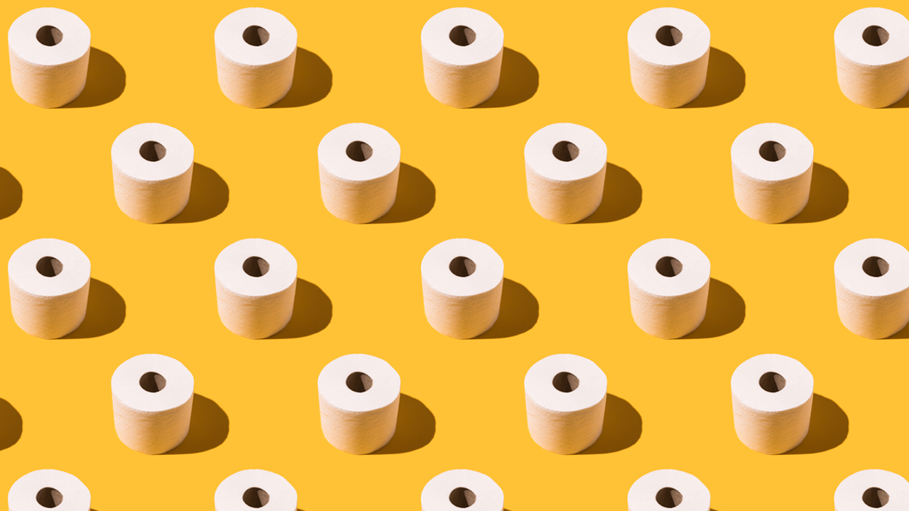 White rolls of toilet paper in a repeating pattern on a solid yellow background.