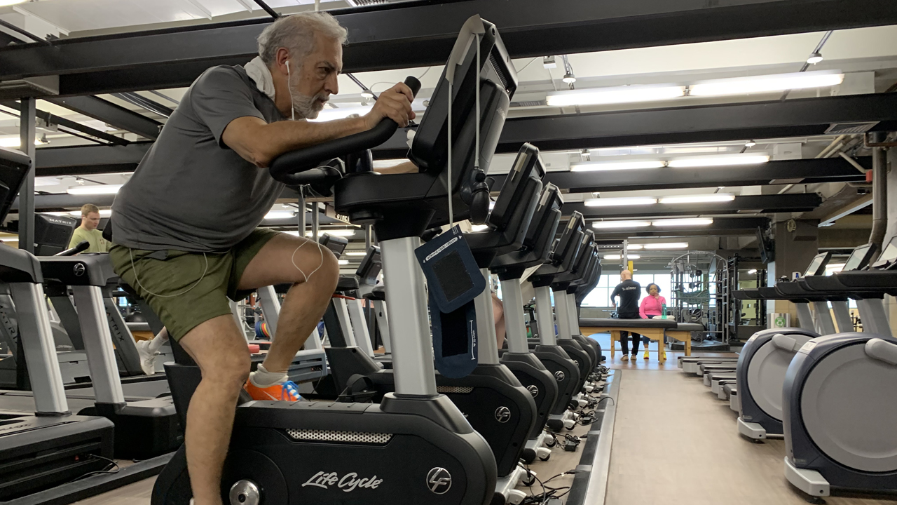 Person riding a stationary bike at the gym.