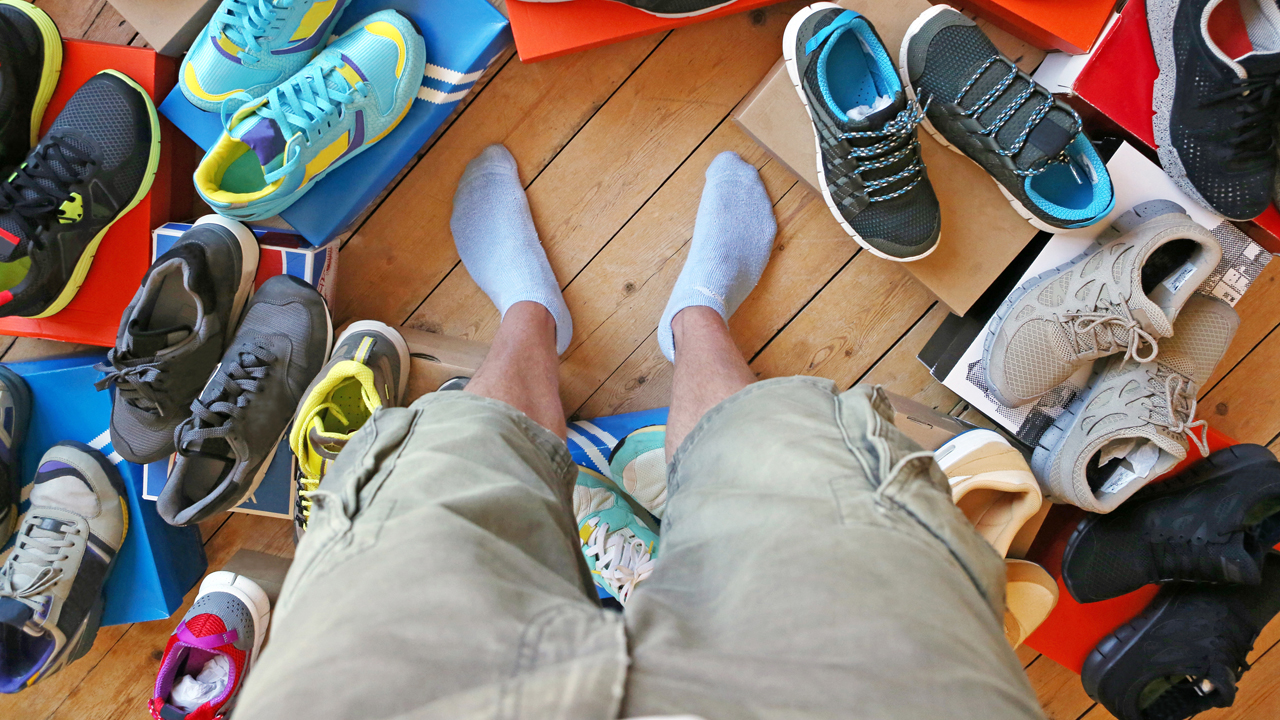 Various running shoes spread out on the floor.