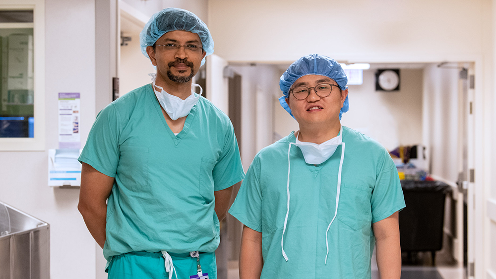 Ankit Bharat, MD and Samuel S. Kim, MD in a hospital corridor.