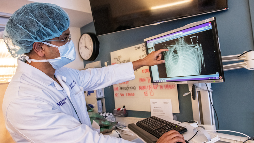Ankit Bharat, MD, looking at chest scans.