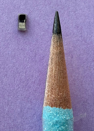 Pacemaker shown next to a pencil tip.