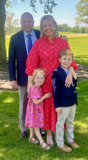 Ashley Daly with her husband and two children outdoors.