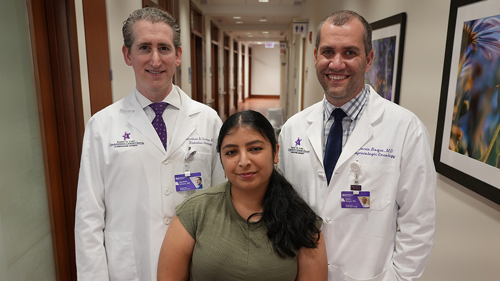 Liliana Castaneda with Dario R. Roque, MD Jonathan B. Strauss, MD in a hospital corridor.