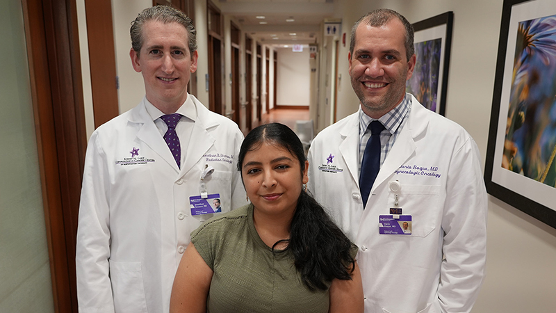 Liliana Castaneda with Dario R. Roque, MD Jonathan B. Strauss, MD in a hospital corridor.