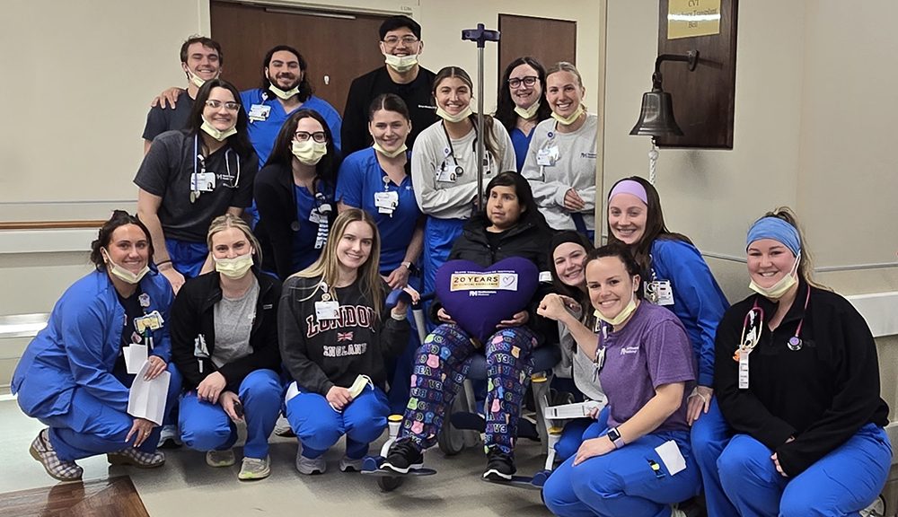 Jessica Lopez and her care team in a hospital corridor.