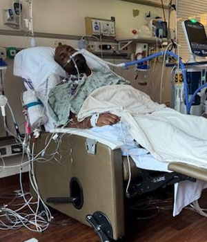 Chris in a hospital bed.