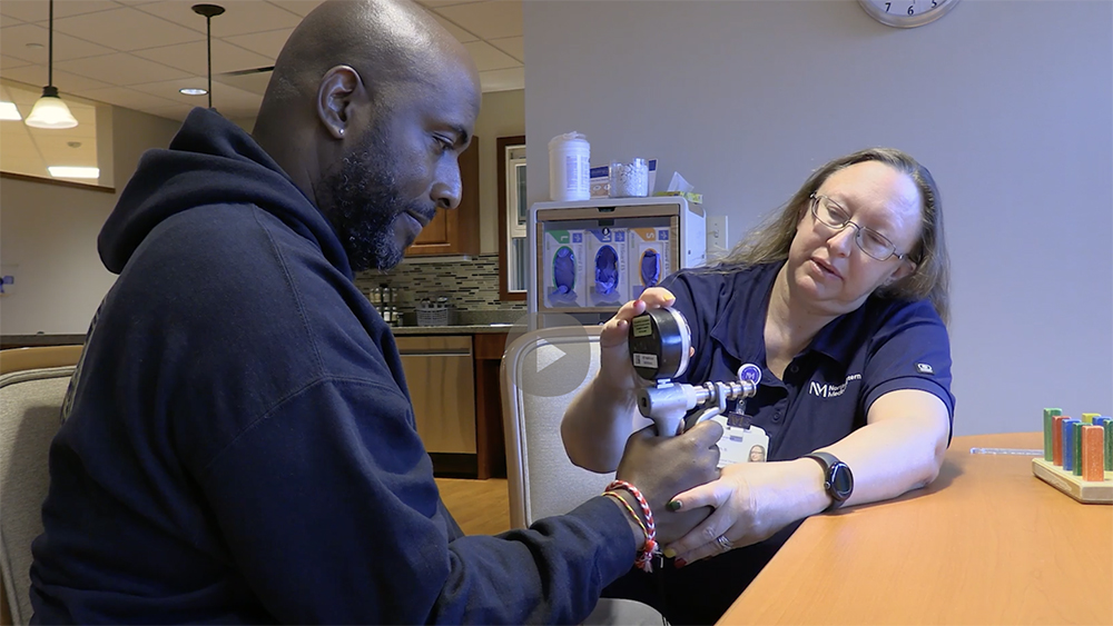 Chris and Beth doing hand-strengthening exercises.