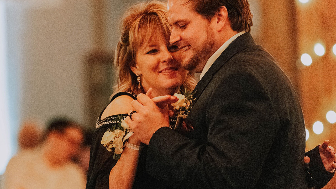 Vicki Strawn dances with her son.