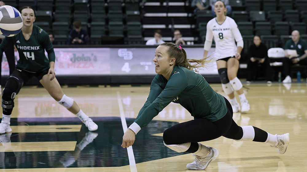 Kendall Schara lunging to hit a volleyball in a game.