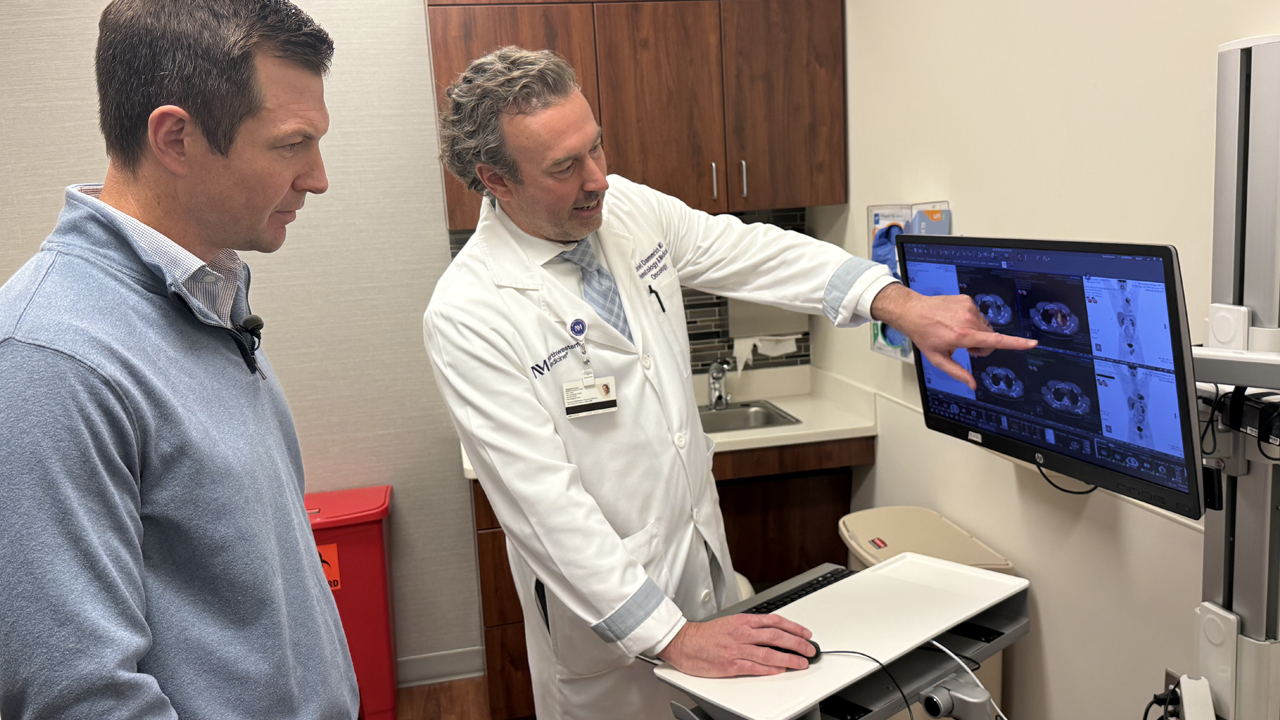 Kevin Humphry looking at a lung scan with Daniel Dammrich, MD.