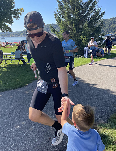 Kevin Humphrey running and high-fiving a child.