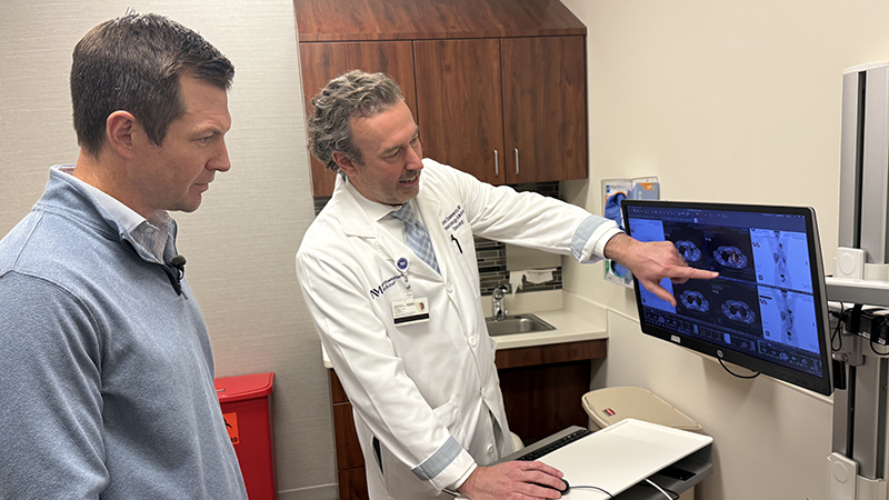 Kevin Humphry looking at a lung scan with Daniel Dammrich, MD.