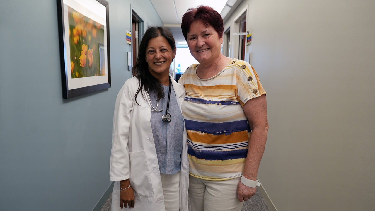 Sunandana Chandra, MD and Bozena Wojtach in a hospital corridor.