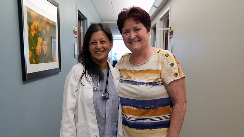 Sunandana Chandra, MD and Bozena Wojtach in a hospital corridor.