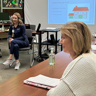 Linda Budziak and Michelle Armour in a conference room.