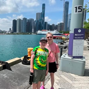Elizabeth and her son pose in front of the Chicago skyline.