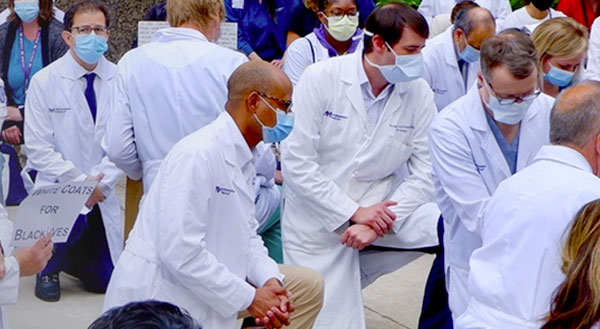 Northwestern Medicine employees kneeling outside