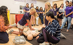 Students performing CPR as part of the Discovery Program.