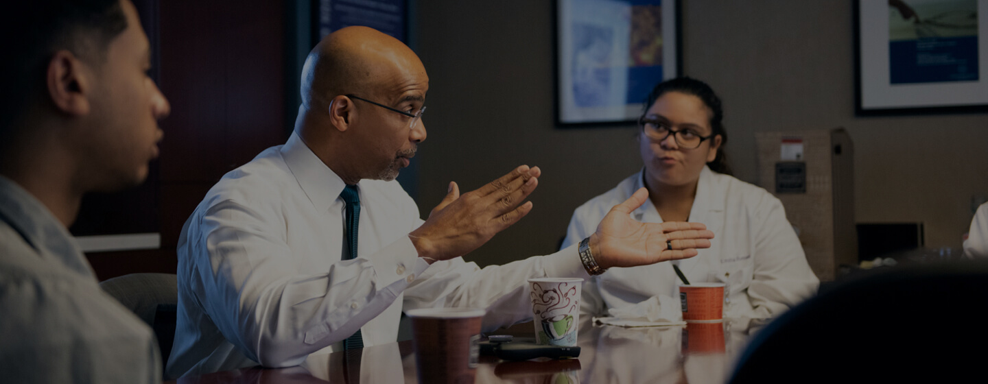 Dr. Yancy talking with colleagues