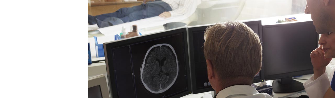 Doctors looking at a brain scan on a monitor