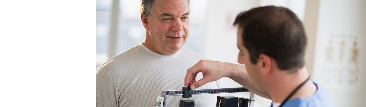 Patient on the scale being weighed
