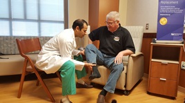 Orthopaedic surgeon Rajeev Jain, MD, checks on the progress of hip replacement patient Dan Pritchard