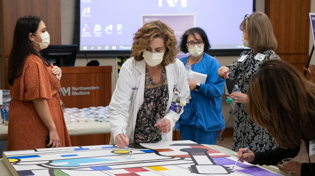 Hospital staff helped paint a mural to honor the strength and teamwork demonstrated throughout the COVID-19 pandemic.