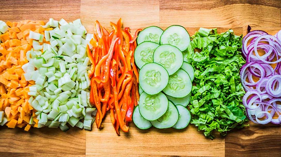 Healthy veggies lined up on a cutting board