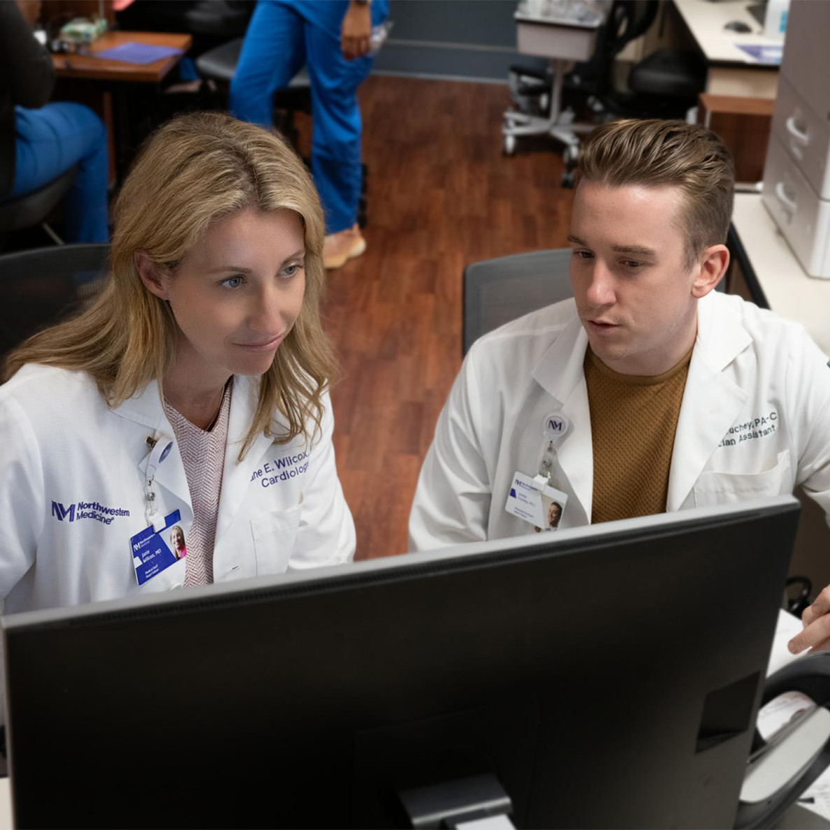Physician and Physician Assistant reviewing the same monitor