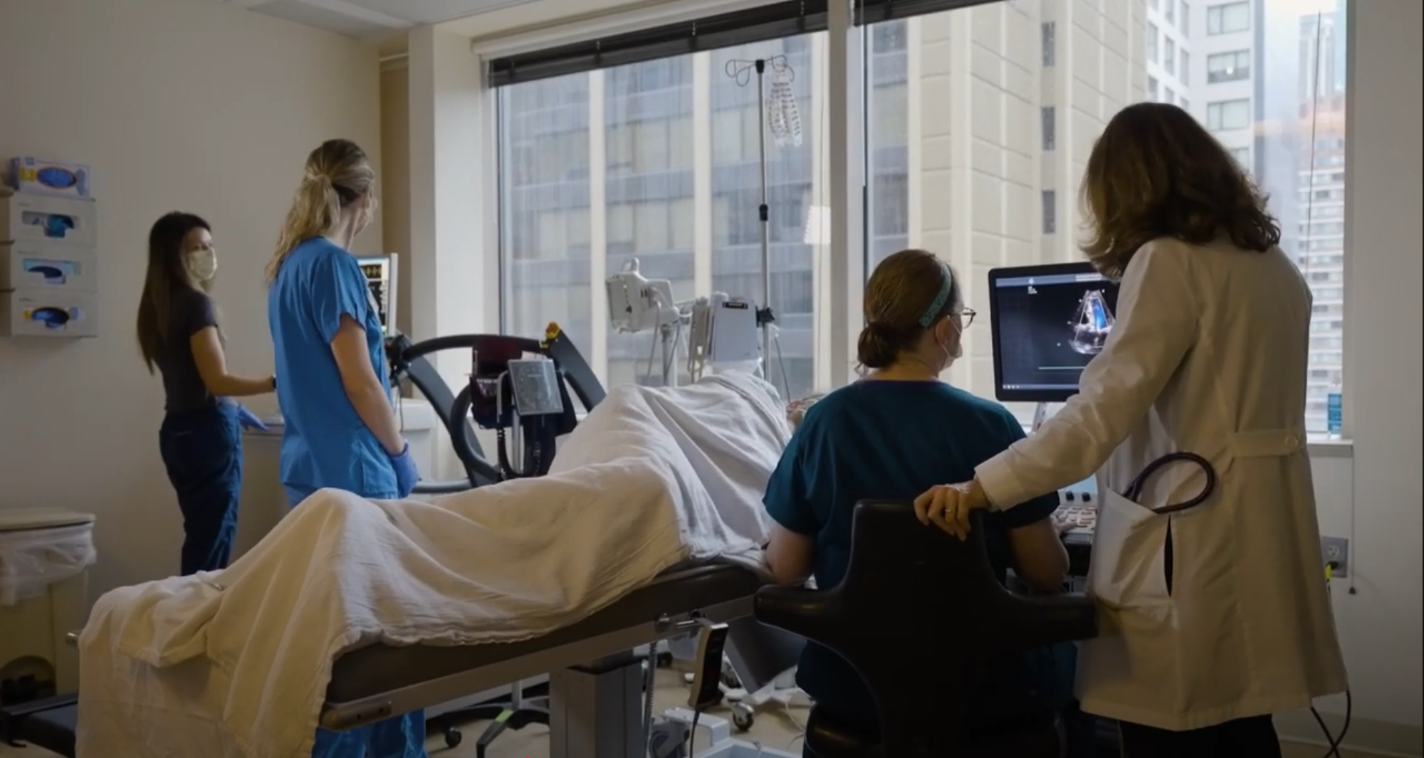 Care team assessing imaging alongside patient