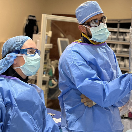 Two physicians speaking in an operating room